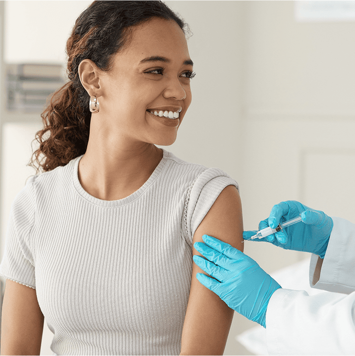 Femme souriante recevant une injection dans le bras